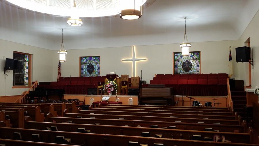 Renovated sanctuary with stained glass and lit cross